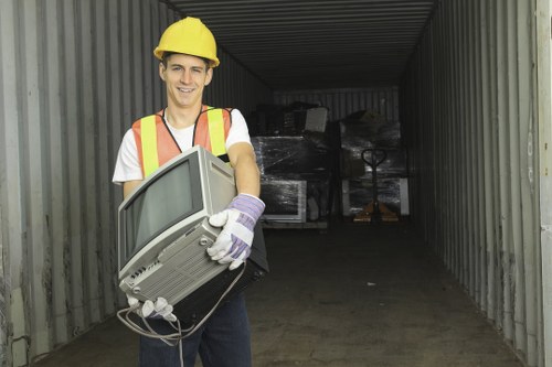 Workers sorting green waste and recyclables during a clearance